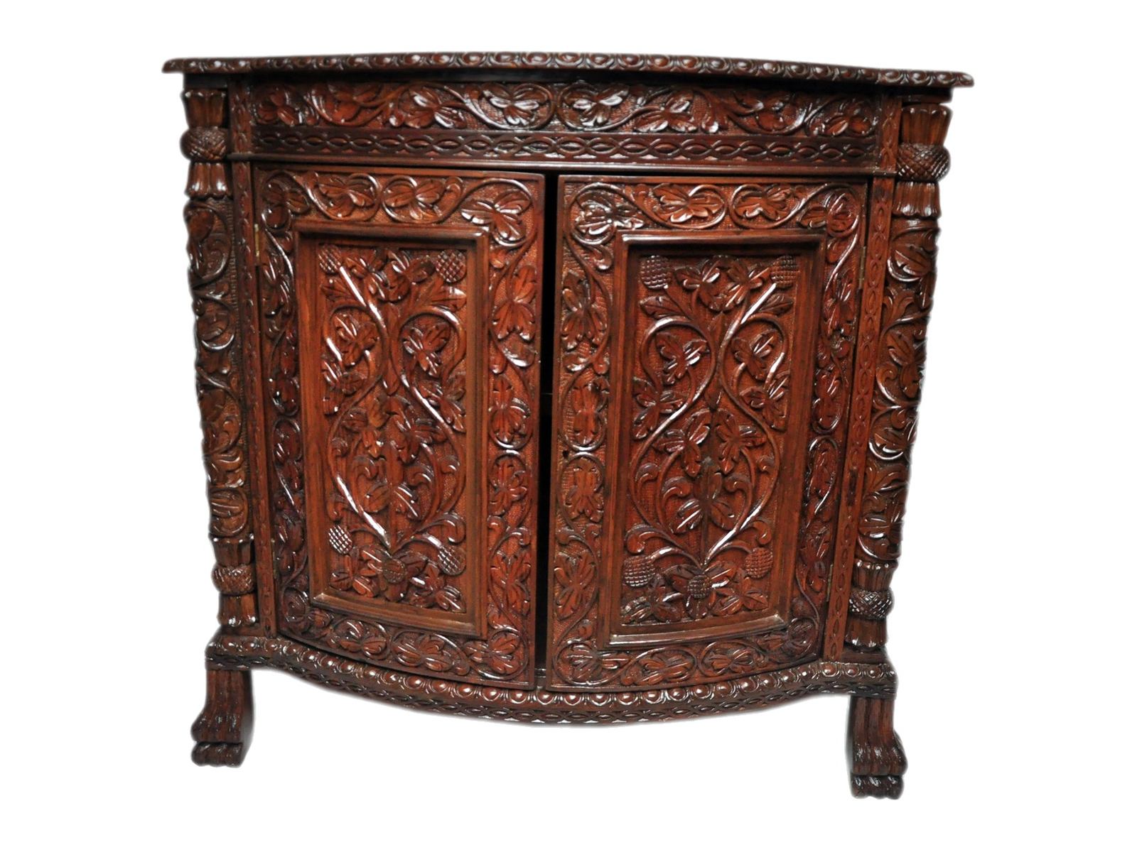 Two-door cabinet by Carpenters Choice — carved vine panels on a bow front; tasselled columns, paw feet