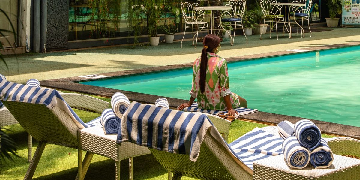 Sun loungers beside the pool at Magnum Resorts, Candolim
